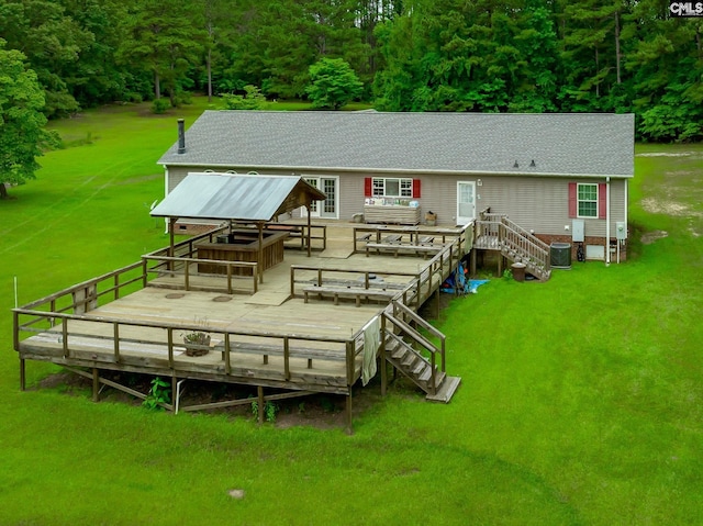 back of house featuring central AC unit, a lawn, a wooden deck, and a gazebo