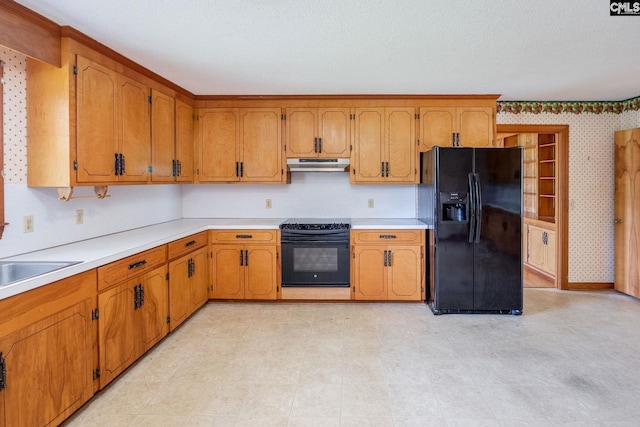 kitchen with black appliances and light tile floors