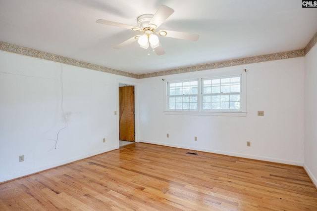 empty room featuring light wood-type flooring and ceiling fan