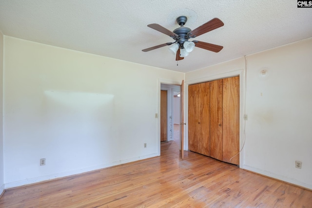 spare room featuring a textured ceiling, ceiling fan, and light hardwood / wood-style flooring