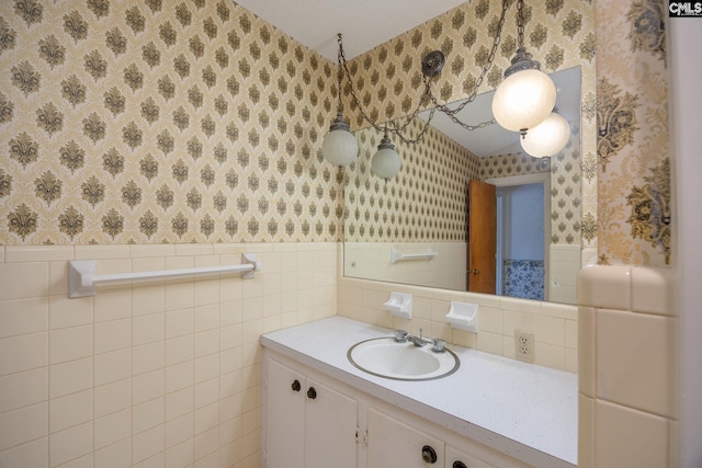 bathroom with tile walls, tasteful backsplash, and vanity