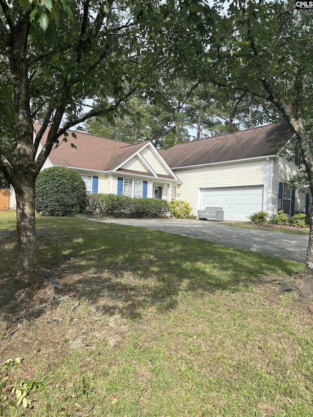 ranch-style home with a garage and a front lawn