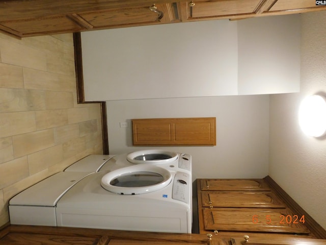 laundry area with independent washer and dryer