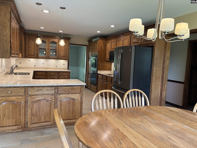 125 Milmont Shores Rd, Chapin, SC 29036 - kitchen with black appliances, a sink, light countertops, decorative backsplash, and a peninsula