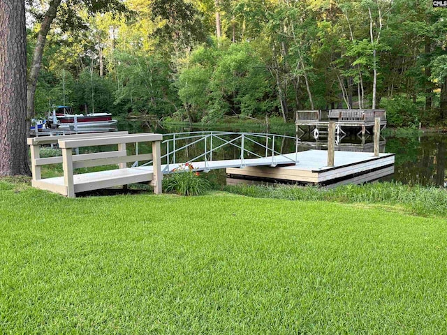 view of dock featuring a lawn