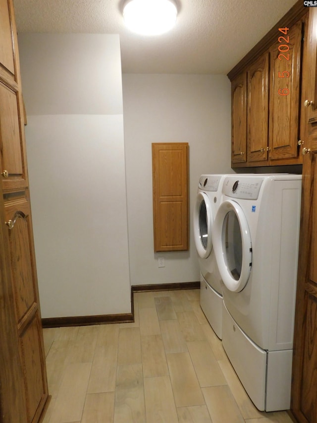 125 Milmont Shores Rd, Chapin, SC 29036 - washroom with separate washer and dryer, a textured ceiling, and cabinet space