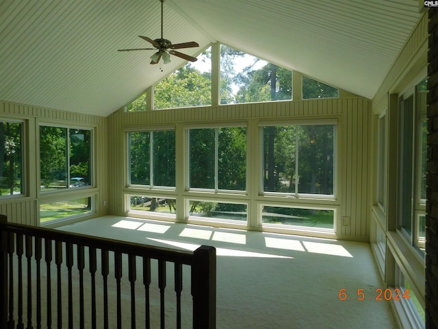 unfurnished sunroom with ceiling fan, plenty of natural light, and lofted ceiling