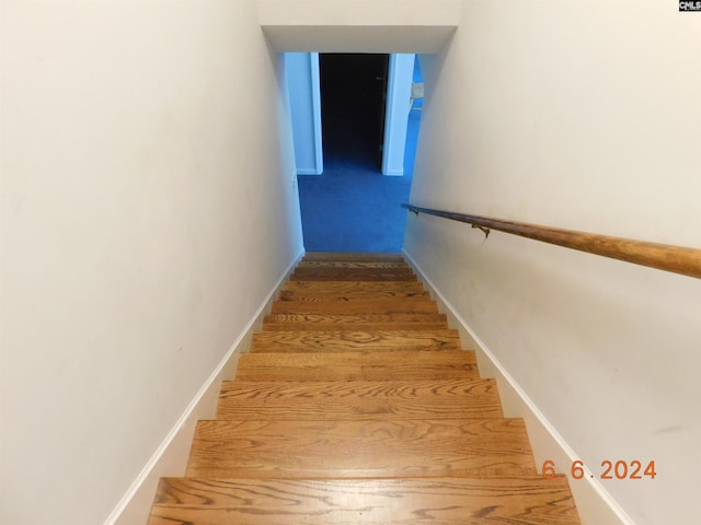 stairway featuring hardwood / wood-style flooring