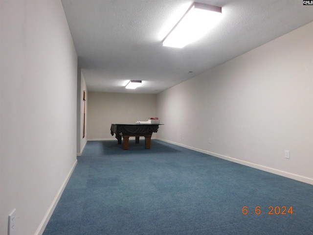 playroom featuring dark colored carpet, a textured ceiling, and billiards