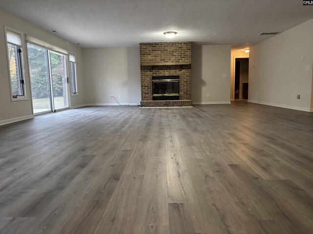 125 Milmont Shores Rd, Chapin, SC 29036 - unfurnished living room featuring dark wood-type flooring, a fireplace, and baseboards