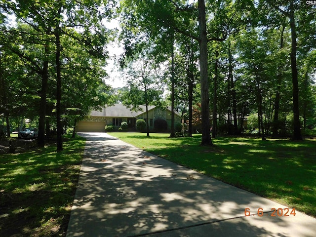 single story home with a garage and a front yard