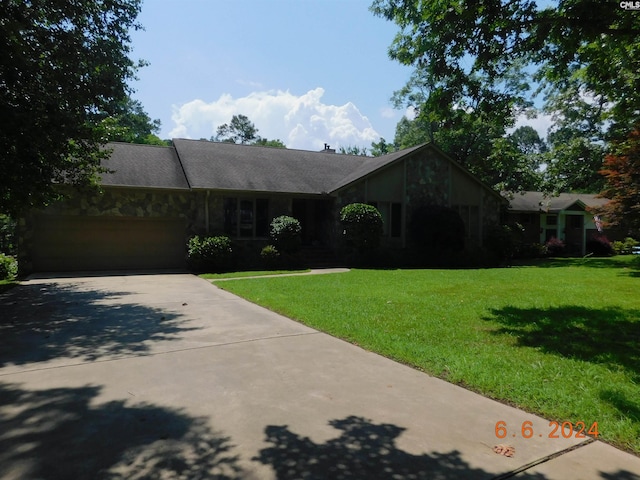 ranch-style house with a garage and a front lawn