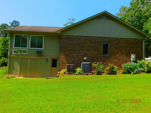 back of house featuring central AC and a lawn