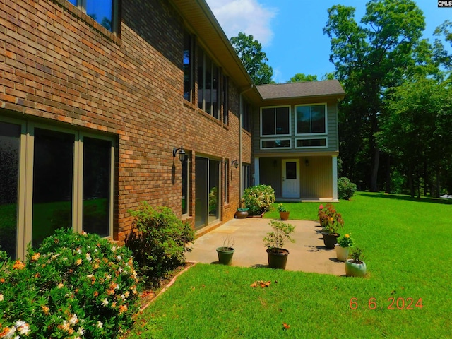 back of house featuring a patio and a lawn