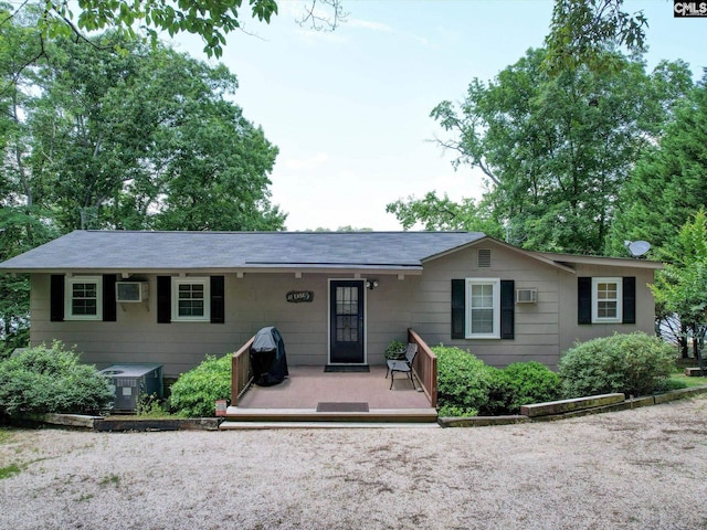 view of front of house featuring central air condition unit and a wall mounted AC