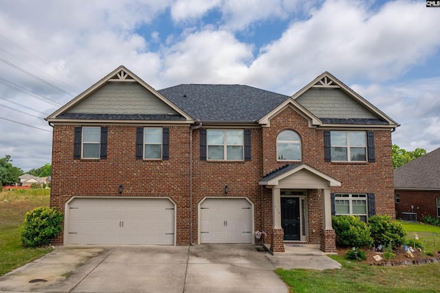 craftsman house with central AC unit and a garage