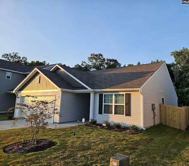 view of front of house featuring a garage and a front lawn