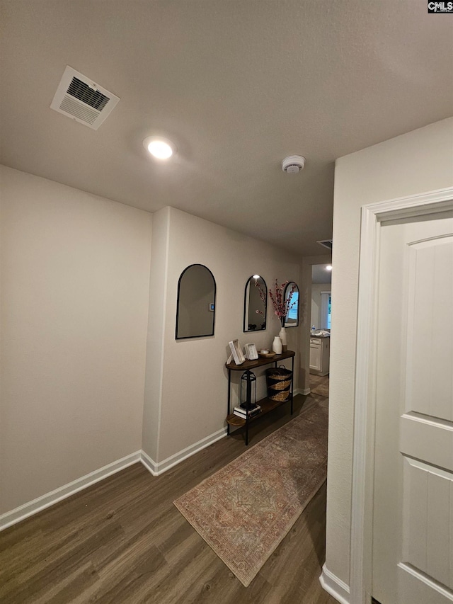 hallway with dark hardwood / wood-style floors