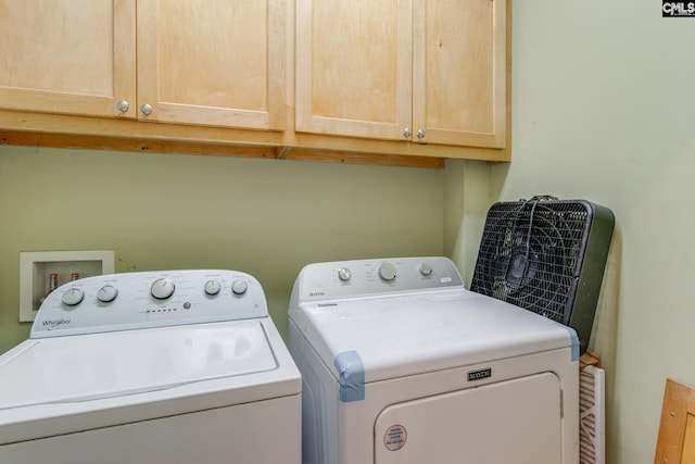 laundry room with cabinet space and separate washer and dryer