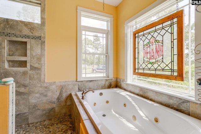 bathroom featuring a tub with jets