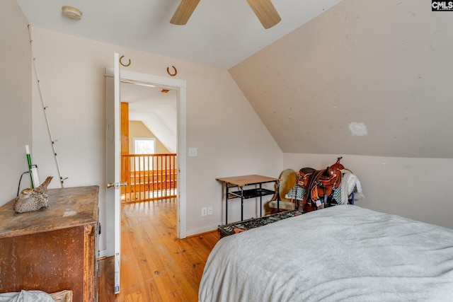 bedroom with lofted ceiling, a ceiling fan, and light wood-style floors