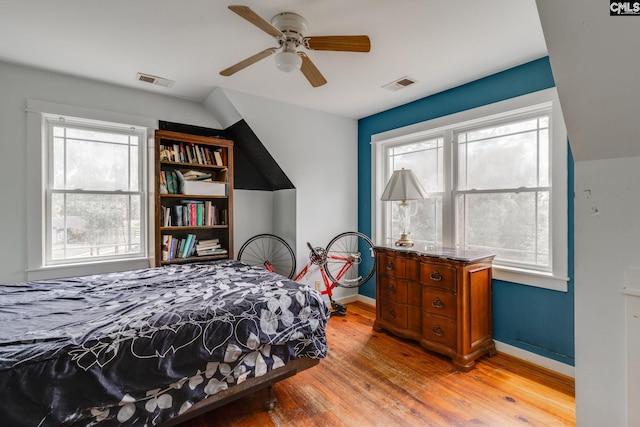 bedroom featuring light wood-type flooring, baseboards, visible vents, and ceiling fan