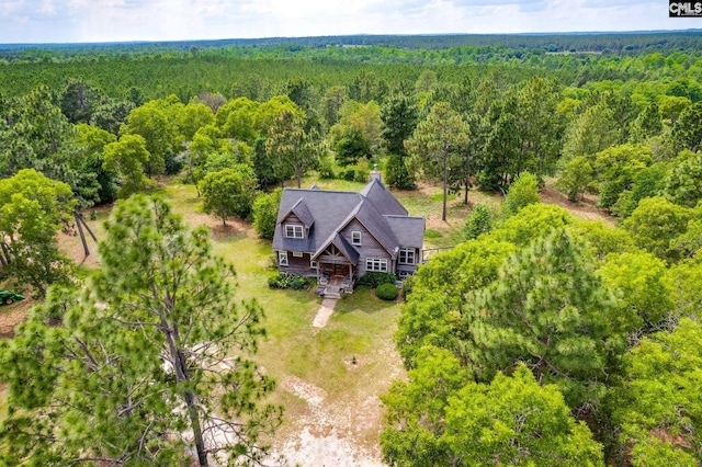 drone / aerial view with a wooded view