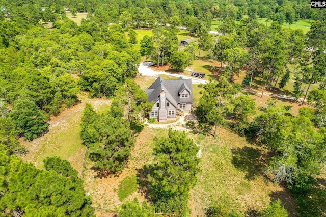 birds eye view of property with a view of trees