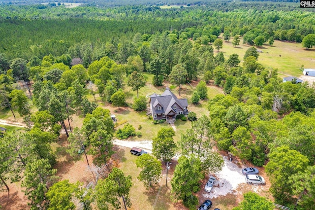 birds eye view of property with a forest view