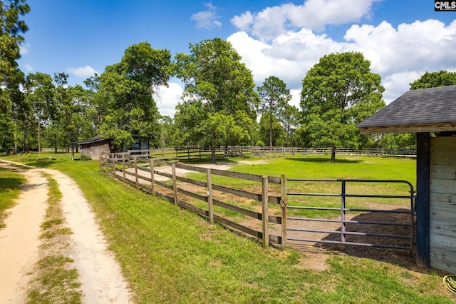 exterior space featuring a rural view and a lawn