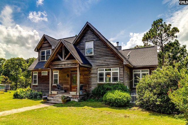 view of front of property with a porch and a front yard