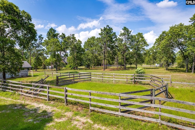 view of yard featuring fence and a rural view