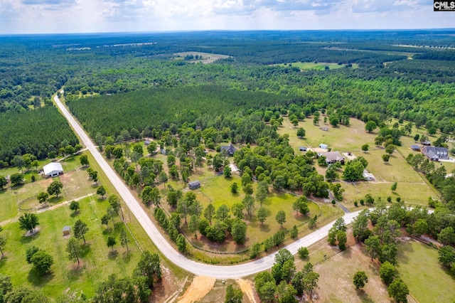 birds eye view of property featuring a forest view