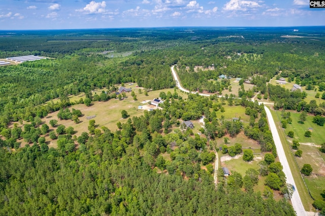 birds eye view of property with a forest view