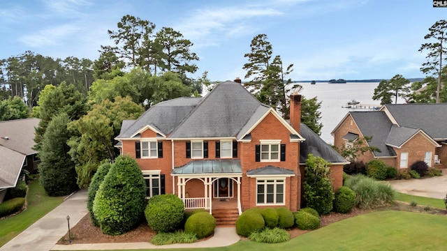 view of front of property featuring covered porch and a water view