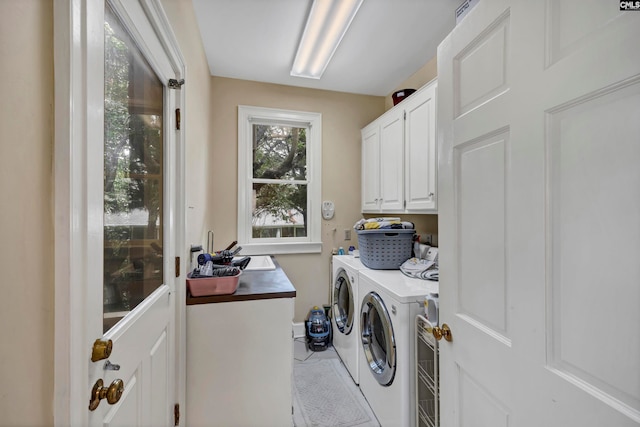 laundry room with cabinets and washing machine and dryer