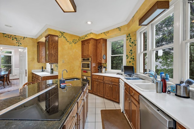 kitchen featuring stainless steel appliances, light tile flooring, sink, and ornamental molding