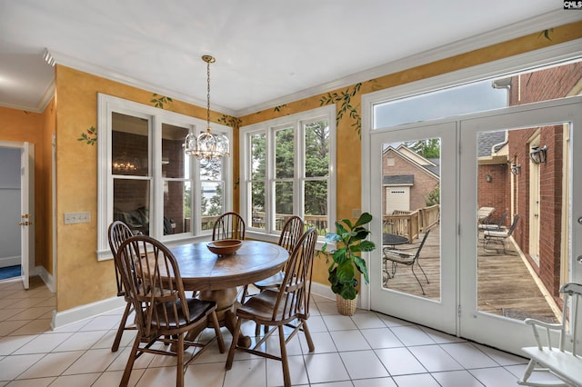 tiled dining room featuring a chandelier and ornamental molding