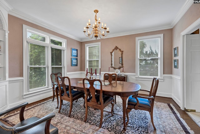 dining room with a chandelier, hardwood / wood-style flooring, and ornamental molding