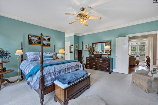 carpeted bedroom featuring ceiling fan and crown molding