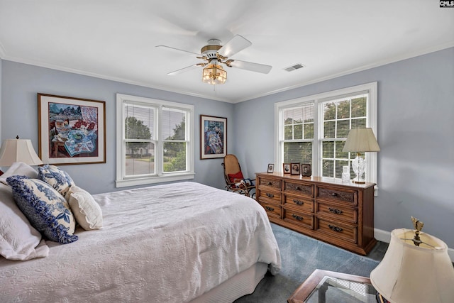 bedroom with ornamental molding, multiple windows, and ceiling fan