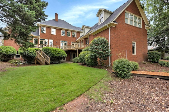 rear view of house featuring a deck and a lawn