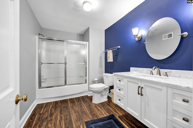 bathroom featuring wood-type flooring, vanity, and toilet