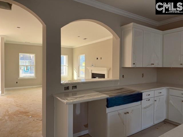 kitchen featuring white cabinetry and ornamental molding