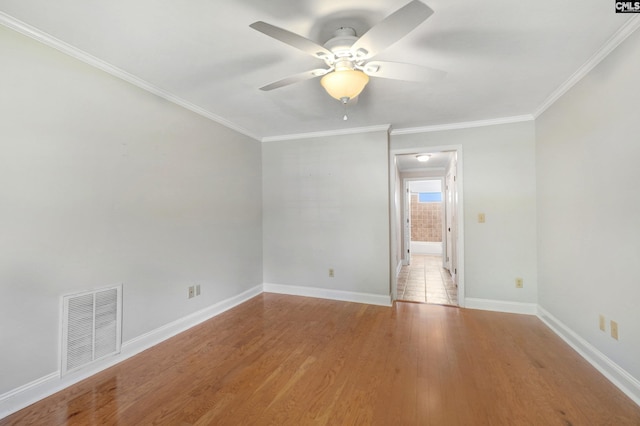 empty room with ornamental molding, light hardwood / wood-style floors, and ceiling fan