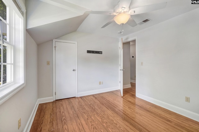 unfurnished bedroom featuring lofted ceiling, light hardwood / wood-style floors, and ceiling fan