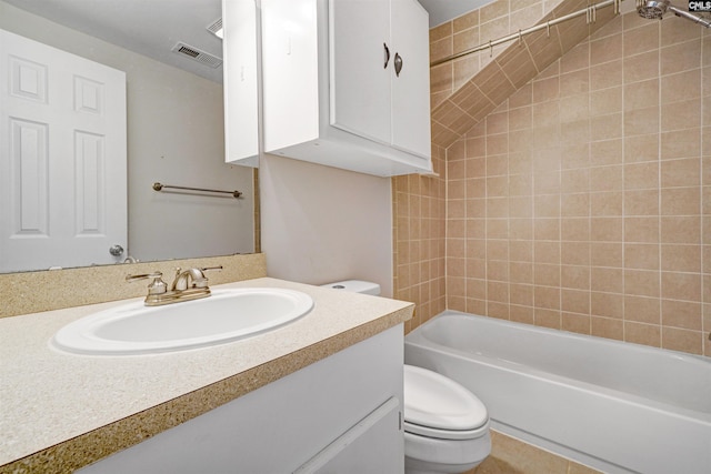 full bathroom with vanity, toilet, and tiled shower / bath