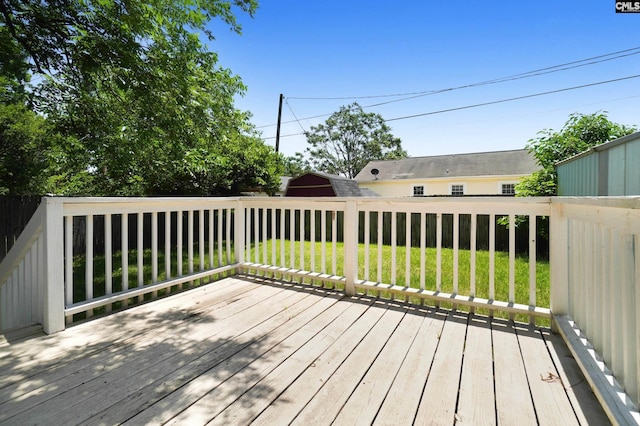 wooden deck featuring a yard