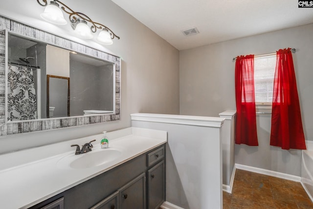 bathroom with a shower with shower curtain and vanity