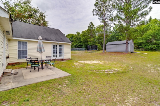 view of yard with a storage shed, a trampoline, and a patio